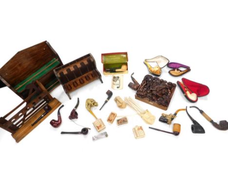 Various pipes, smoking accessories, an oak pipe rack, 28cm high, a heavily carved oak case stand, various pipes, associated i
