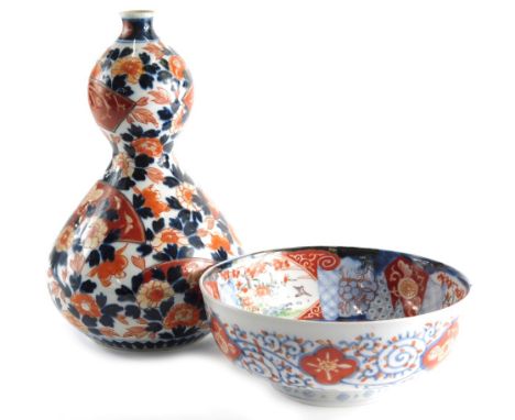 A 19thC Japanese Imari double gourd vase, typically decorated with flowers, unmarked, 28cm high, and an Imari bowl. (2)