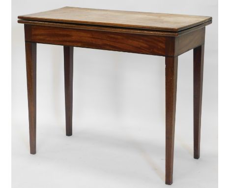 An early 19thC mahogany tea table, the D shaped top with a reeded edge, over three plain panel frieze, on turned tapering leg