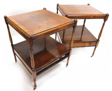 A pair of yew two tier lamp tables, each with a drawer, on turned supports with baluster supports and turned legs terminating