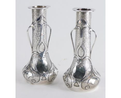 A pair of Art Nouveau vases, with cylindrical stems, bulbous bodies and a blind fret decoration with lotus flowers, on circul