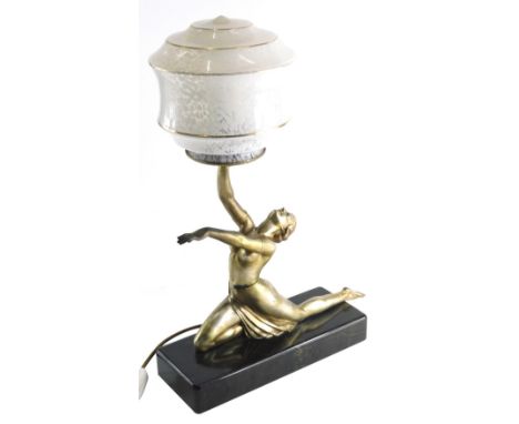 An Art Deco style table lamp, formed as a nude lady holding speckled glass shade with gilt highlights and a black marble fini