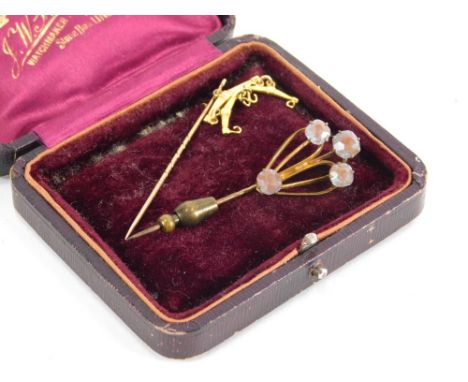 An Edwardian stick pin, with partial turned stem and unusual hanger style top, 8cm high, and another smaller. (2, 1 cased) 