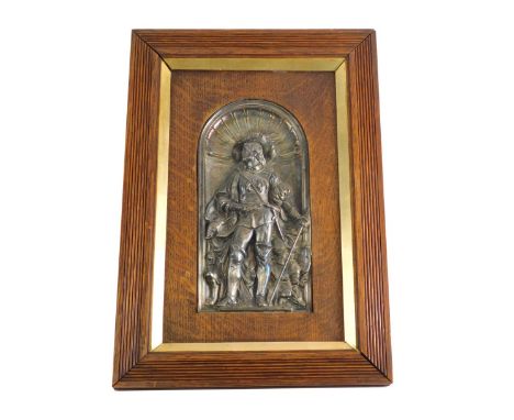 An early 20thC oak framed panel, raised with a metal figure of a caviller, with dead game and griffins in the distance, in a 