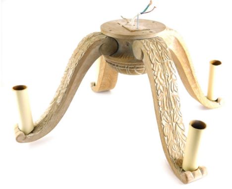 A limed oak four branch ceiling light, carved with leaves, 68cm wide.