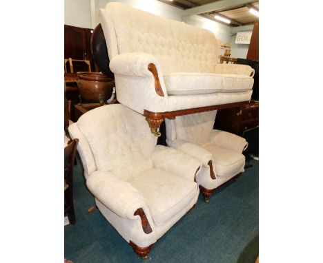 A walnut three piece suite, comprising two-seater sofa, and two armchairs, upholstered in gold pattern fabric with show frame