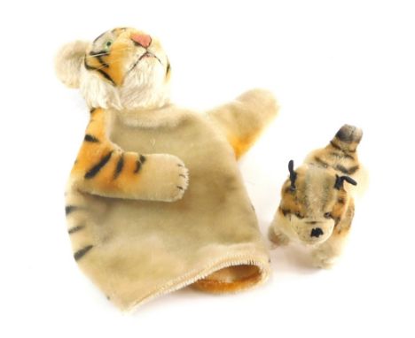 A 20thC tiger glove puppet, 16cm high and a toy dog with fixed limbs.(2)