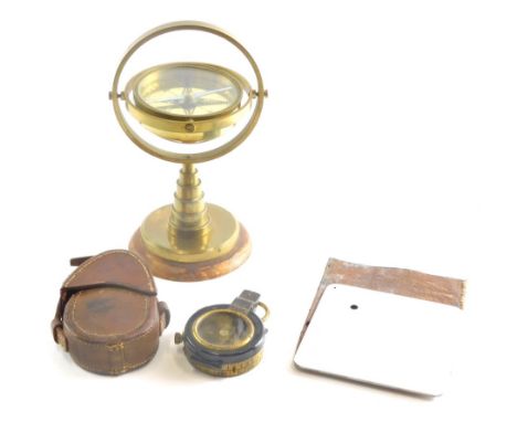 A 20thC brass table compass, 21cm high, a Verner's patent compass in leather case and a World War II heliograph plane spottin