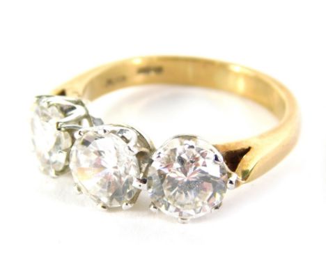 A CZ three stone ring, quartz set, on plain shank, size O.