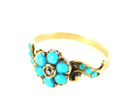 An early 20thC dress ring, florally set with turquoise, unmarked. 