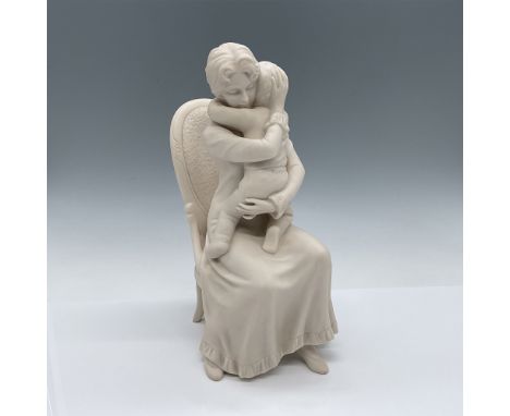 This Goebel figurine, titled "Hug Me," was sculpted by Irene Spencer in 1985. Crafted in matte finish, it depicts a tender mo
