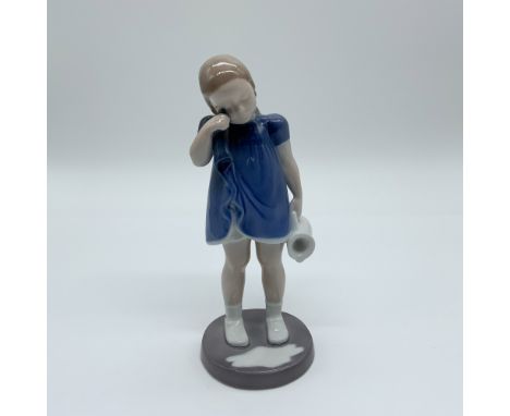 Delicate Bing &amp; Grøndahl porcelain figurine, Spilt Milk (#2246), depicting a young girl in a blue dress wiping her eyes w