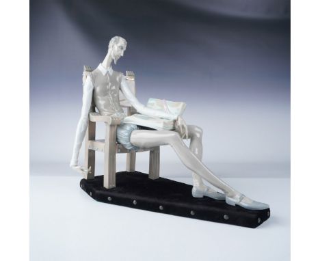 This Lladro porcelain figurine portrays the iconic character Don Quixote seated in a chair, reflecting his contemplative and 