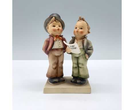 Matte hand painted porcelain figure featuring two kinds singing to a music sheet. M.I. Hummel impressed. Goebel backstamp.Dim