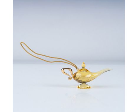 Presenting a dazzling Swarovski crystal ornament inspired by the Magic Lamp from Disney's Aladdin. This exquisite piece is me