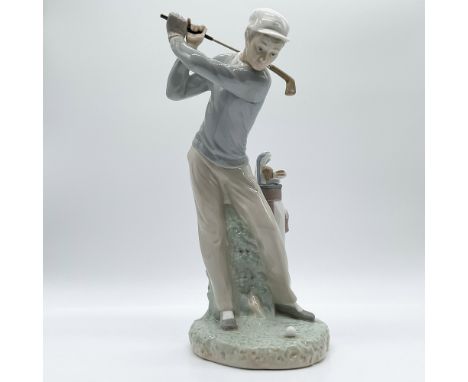 This is a Lladro porcelain figurine titled Golfer, designed with intricate detail showcasing a golfer mid-swing. Produced in 