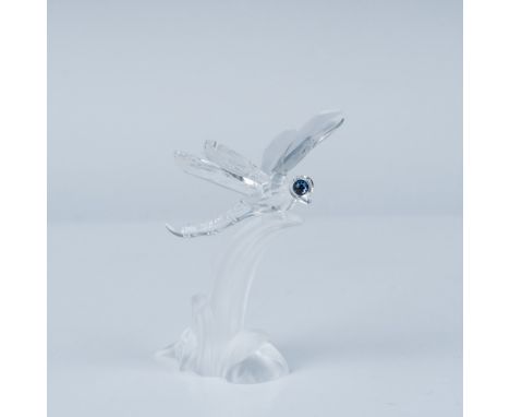 A stunning Swarovski crystal figurine depicting a delicate dragonfly. This piece showcases Swarovski's exceptional craftsmans