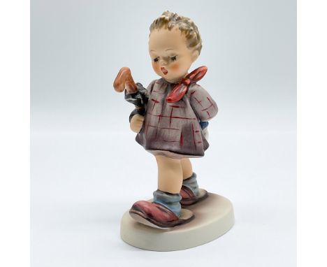 A charming Goebel Hummel figurine titled "The Professor," marked as the first issue from 1992. This hand-painted porcelain fi