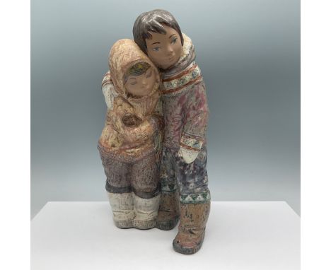 Lladro figurine titled "Eskimo Boy and Girl," item number 01012038, sculpted by Juan Huerta. This beautifully detailed piece,