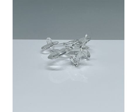 This Swarovski crystal airplane figurine, designed by Adi Stocker, showcases the company's renowned precision-cut crystal cra