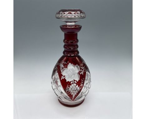 This elegant cut-to-clear red glass decanter stands 11.25"H and features intricate floral and grape designs, showcasing excep