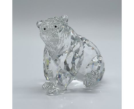 This retired Swarovski crystal grizzly bear is a part of the "Rare Encounters" collection. It features a clear, faceted cryst