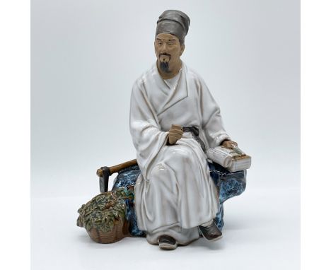 A vintage 1950s hand-painted Mudman figurine depicting a seated Chinese scholar, crafted in traditional glazed porcelain. Thi