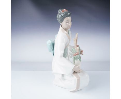 Elegant Nao by Lladro porcelain figurine featuring a kneeling geisha dressed in a flowing white kimono with a pale blue obi, 