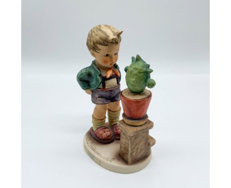 Goebel Hummel figurine Confidentially (#314), featuring a young boy curiously inspecting a potted cactus. Marked with the Goe
