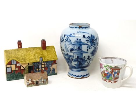 A Delft blue and white vase, 16 cm high, a porcelain polychrome cream jug, 8 cm high, a W H Goss cottage pastille burner, 16 