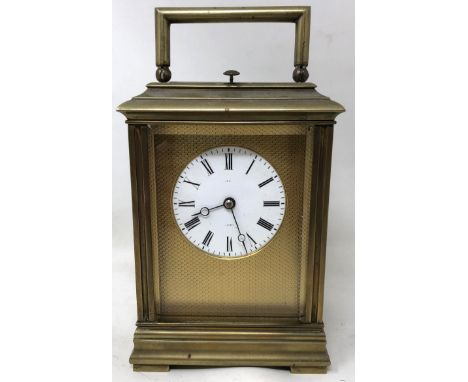 A carriage clock, with enamel dial in a brass and glass caseMovement appears complete, we have not seen this running, probabl