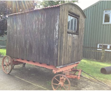 A late 19th/early 20th century shepherd's hut, in largely original condition, with steps and a draw bar, the interior painted