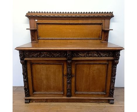 A Victorian oak buffet, with a raised back, on a base with two drawers and two cupboard doors, 153 cm wide 