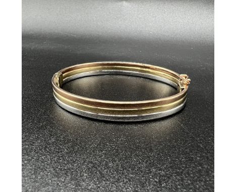 9ct tri-colour gold bangle,
8mm depth,
7 1/2 inch diameter,
fitted with safety clasp,
14.1 grams,
excellent condition