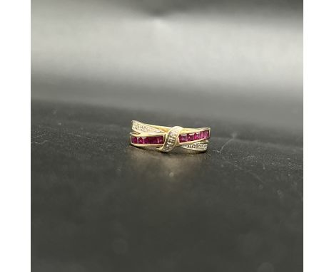 9ct yellow gold ruby and diamond cross over style ring,
princess cut rubies and round brilliant cut diamonds,
size L 1/2,
2.5