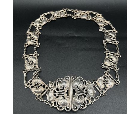 A Silver Art nouveau belt,
hallmarked silver,
s * b anchor and a lion,
28 inches long x 2 1/2 inches wide,
188.4 grams