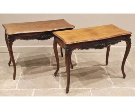 A pair of Louis XV style walnut console tables, early 20th century, each with a moulded serpentine top above a relief carved 
