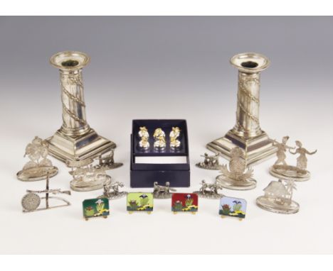 A selection of novelty place card holders, to include five Burmese silver coloured examples, modelled as figures, fruit and f