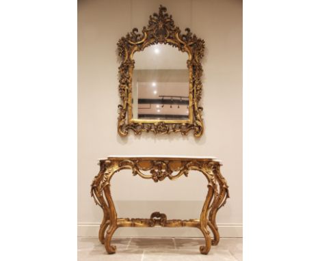 A Rococo revival giltwood and gesso marble top console table and mirror, mid 20th century, the arched mirrored plate within a