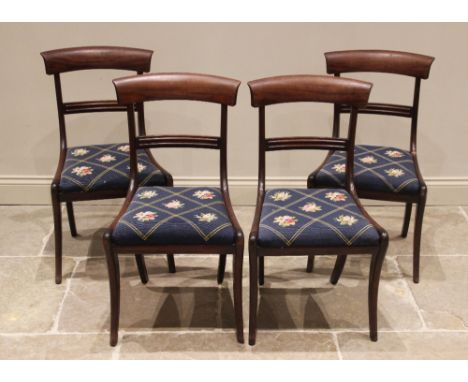 A set of four mahogany rail back dining chairs, mid 19th century, each chair with a concave rail back over a drop-in seat, up