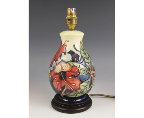 A Moorcroft table lamp decorated in the "Simeon" pattern by Philip Gibson, of baluster form on turned wooden base, 27.7cm hig