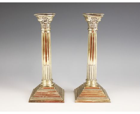 A pair of George V silver candlesticks, marks for 'WS', Birmingham 1921, the weighted stepped square bases with beaded border