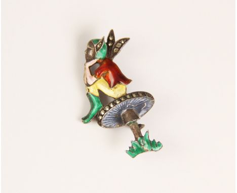 A silver marcasite and enamel brooch, modelled as a pixie seated upon a toadstool, decorated in polychrome enamel hues, with 