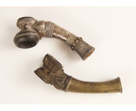 A Burmese white metal pipe, 19th century, with filigree wire work, 10.5cm long, with a Burmese clay and brass mounted pipe, 1