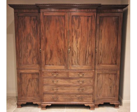 A large Chippendale revival mahogany breakfront wardrobe, early 20th century, the moulded dentil cornice above a pair of cent