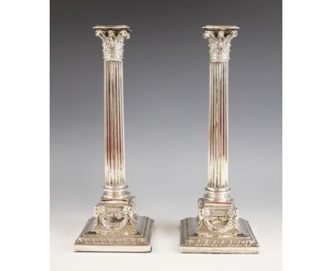 A pair of Edwardian silver candlesticks, Elkington & Co, Birmingham 1901, the weighted square bases decorated with ram's mask