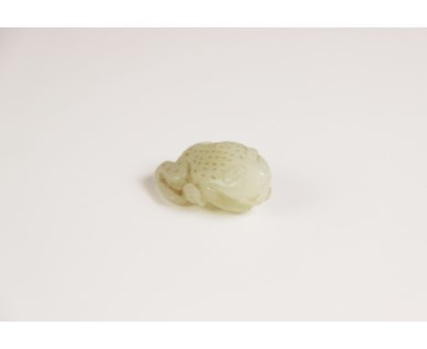 A Chinese pale jade toad, 19th century, the celadon coloured carving modelled grasping a fruiting vine, 4cm longCR: There app