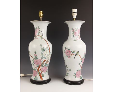 A pair of Chinese famille rose baluster lamp bases of large proportions, 20th century, each decorated with a bird among white