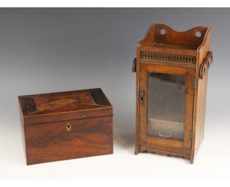 A 19th century parquetry mahogany stationary box, the hinged cover inlaid with geometric banding, opening to a compartmented 