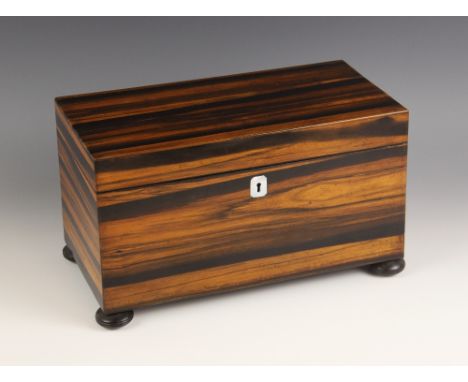 A mid 19th century coromandel tea caddy, of rectangular form, opening to a central aperture and two hinged compartments, upon